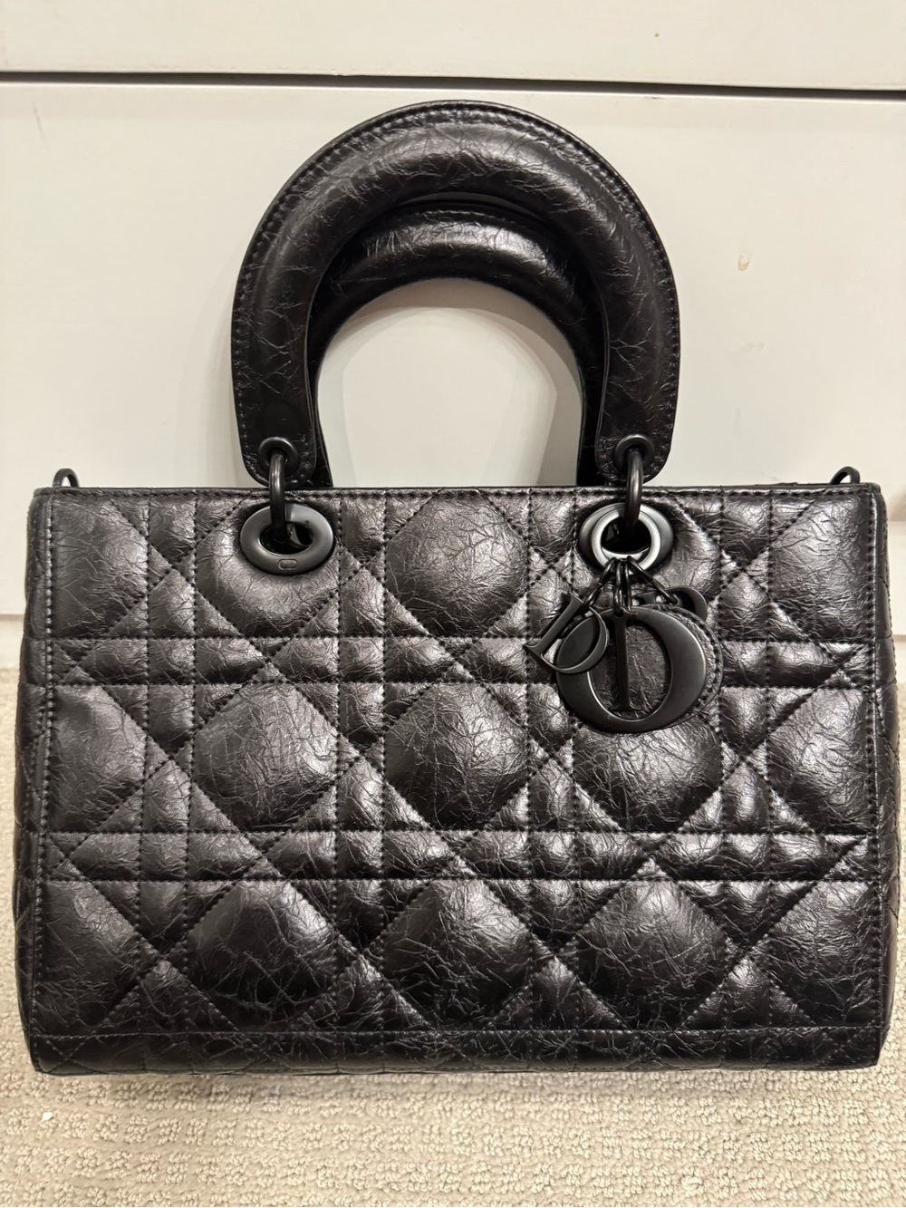 Black Quilted Leather Top-Handle Bag.